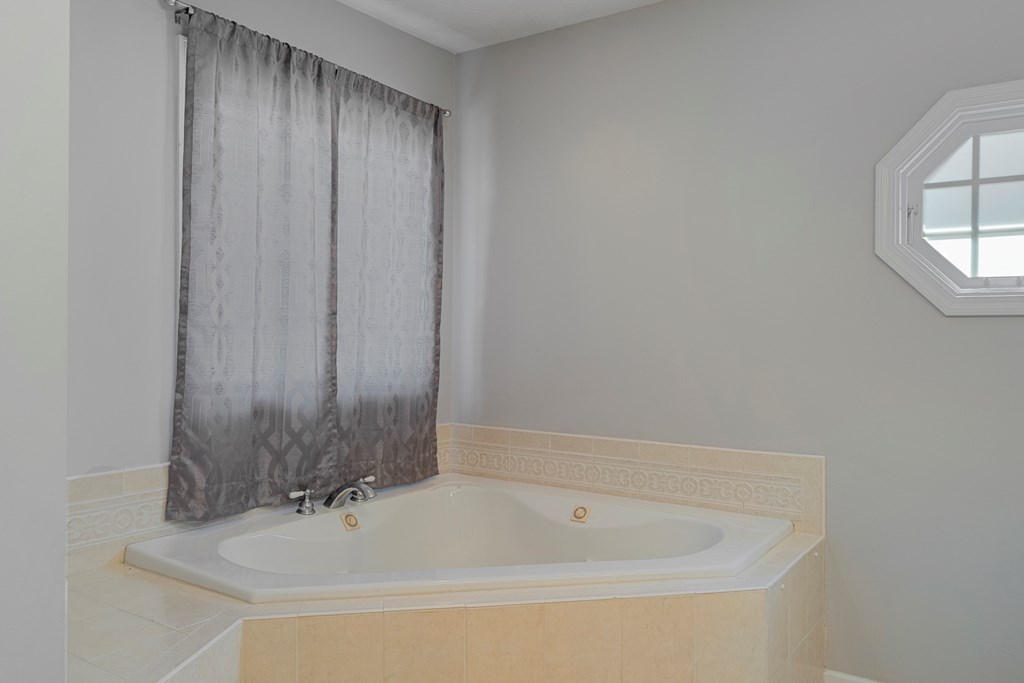 2034 Lee Road Salem, AL 36874 - Photo 20 of 47 a bathroom with a bathtub and a shower