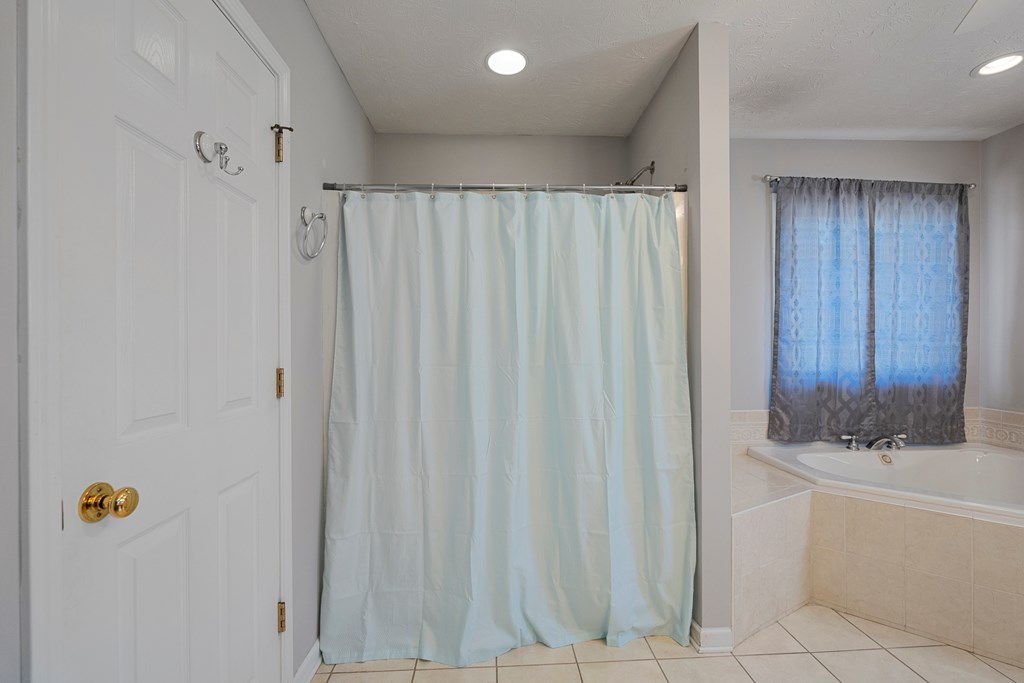 2034 Lee Road Salem, AL 36874 - Photo 21 of 47 a bathroom with a bathtub and shower