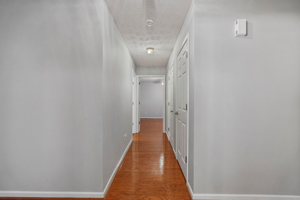 2034 Lee Road Salem, AL 36874 - Photo 23 of 47 a view of a hallway with wooden floor and staircase