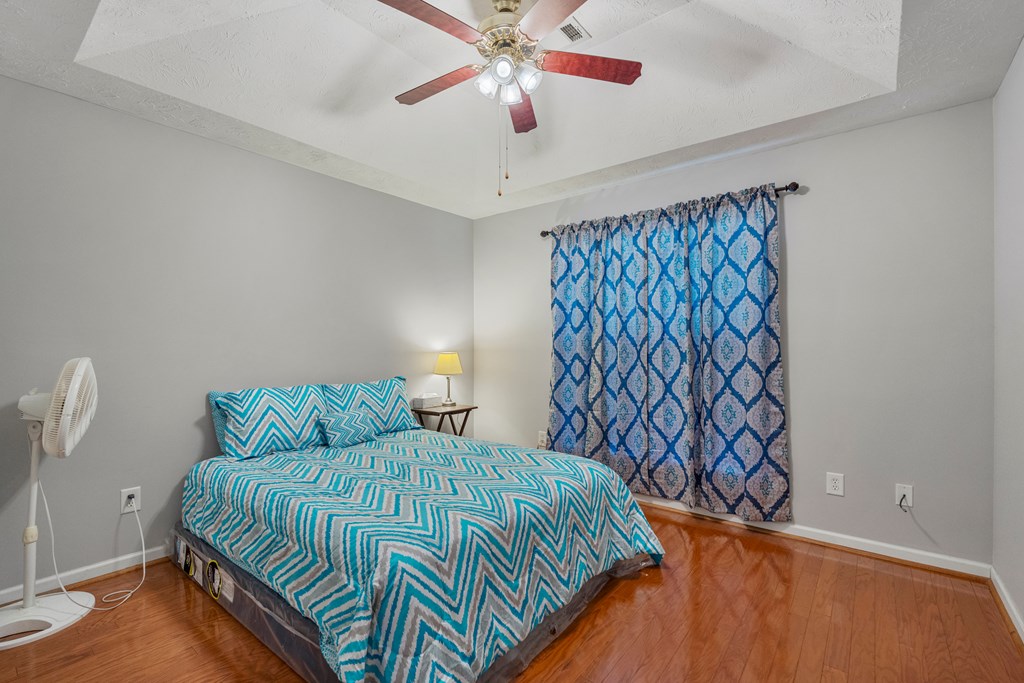 2034 Lee Road Salem, AL 36874 - Photo 24 of 47 a bedroom with a bed and a chandelier