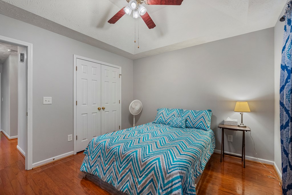 2034 Lee Road Salem, AL 36874 - Photo 25 of 47 a bedroom with a bed and a chandelier