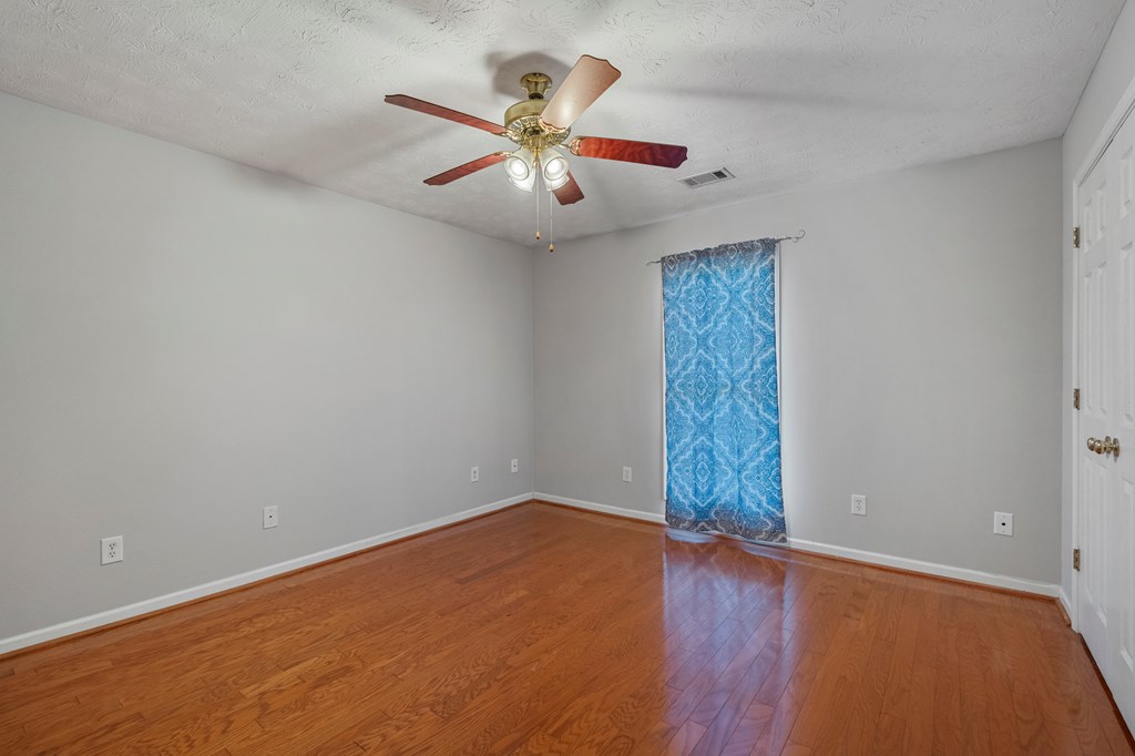 2034 Lee Road Salem, AL 36874 - Photo 26 of 47 an empty room with wooden floor fan and windows