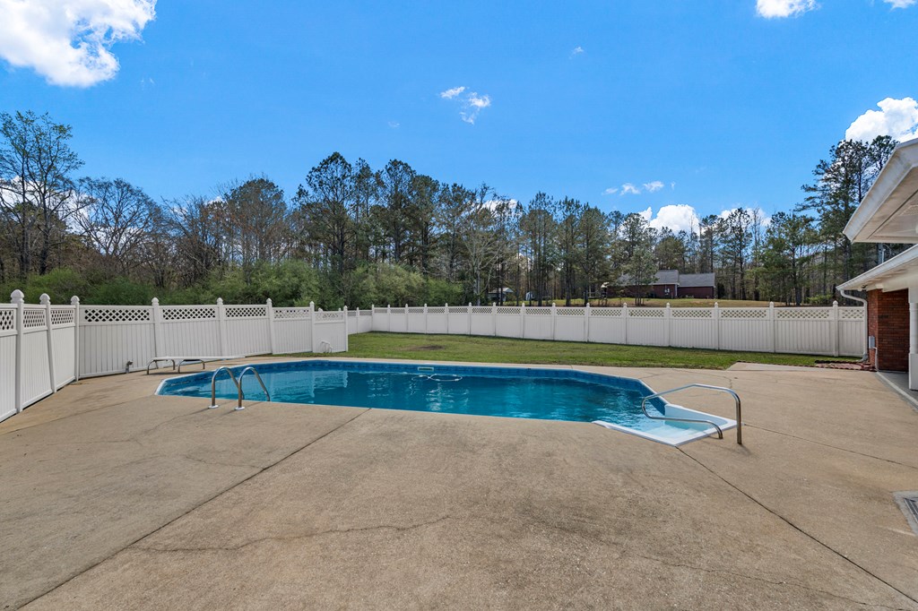 2034 Lee Road Salem, AL 36874 - Photo 37 of 47 a view of a swimming pool with an outdoor space and seating area