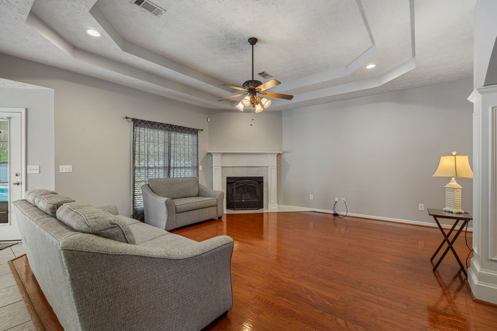 2034 Lee Road Salem, AL 36874 - Photo 7 of 47 a living room with furniture a fireplace and a chandelier