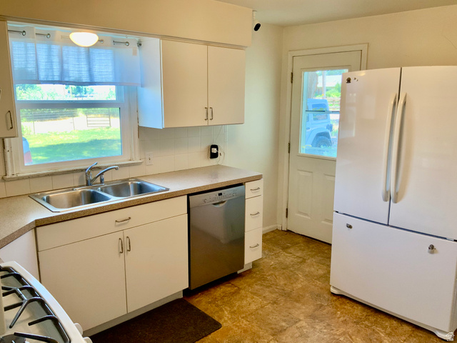 630 North Main Street Monroe, UT 84754 - Photo 5 of 63 Kitchen featuring freestanding refrigerator, backsplash, white cabinetry, dishwasher, and gas stovetop