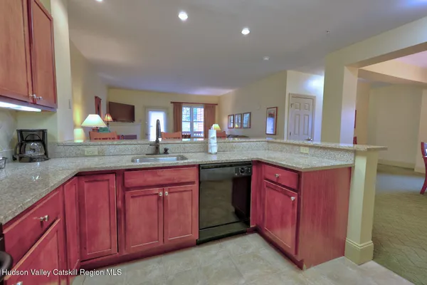 a kitchen with stainless steel appliances granite countertop wooden cabinets a sink and dishwasher