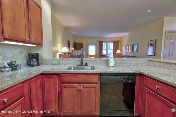 a kitchen with granite countertop a sink stove and cabinets