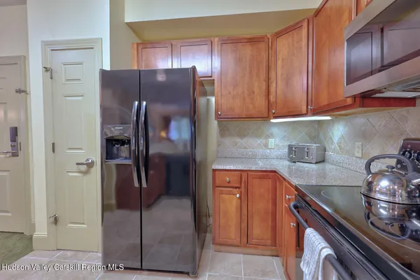 a kitchen with stainless steel appliances granite countertop a refrigerator and a sink