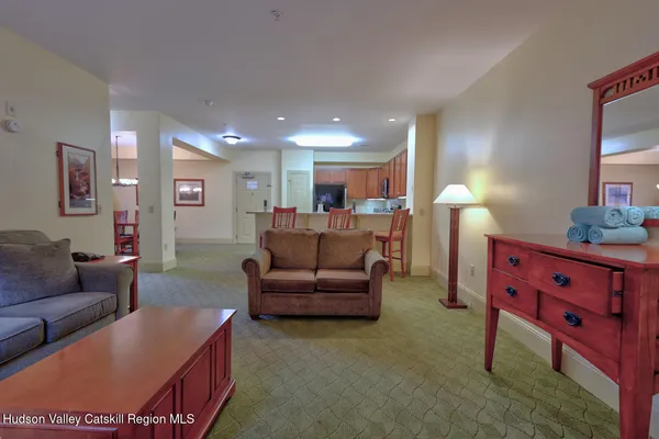 a living room with furniture and a dresser