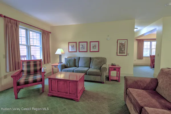 a living room with furniture and a floor to ceiling window