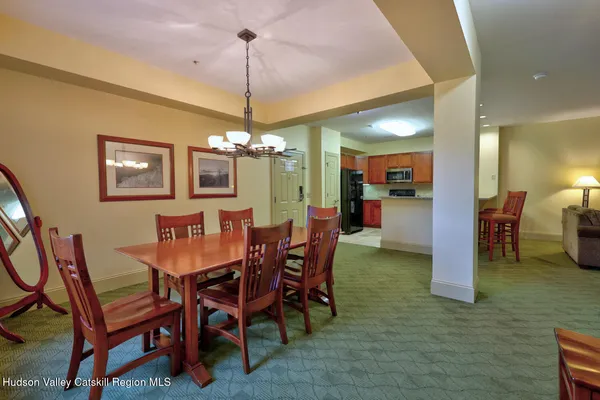 a view of a dining room with furniture and chandelier