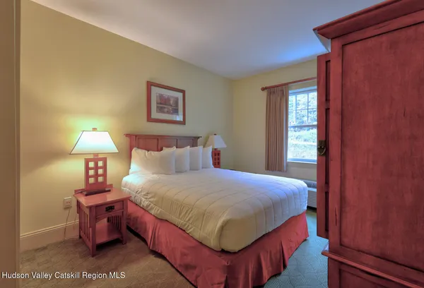 a bedroom with a bed and a lamp