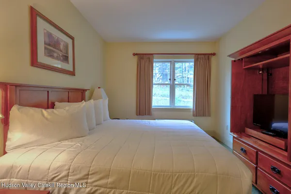 a bedroom with a bed and a television