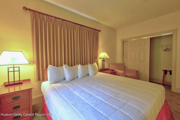 a bedroom with a bed and a lamp