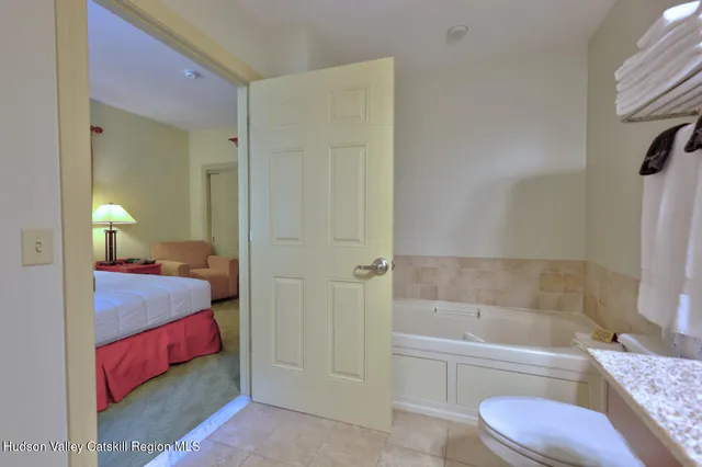 a bathroom with a tub shower sink and toilet