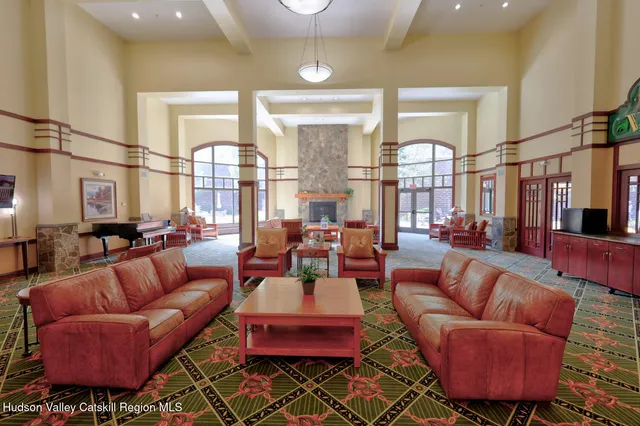 a living room with furniture kitchen view and a large window