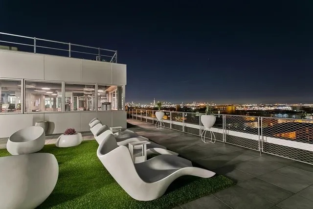 a view of a swimming pool and lounge chairs
