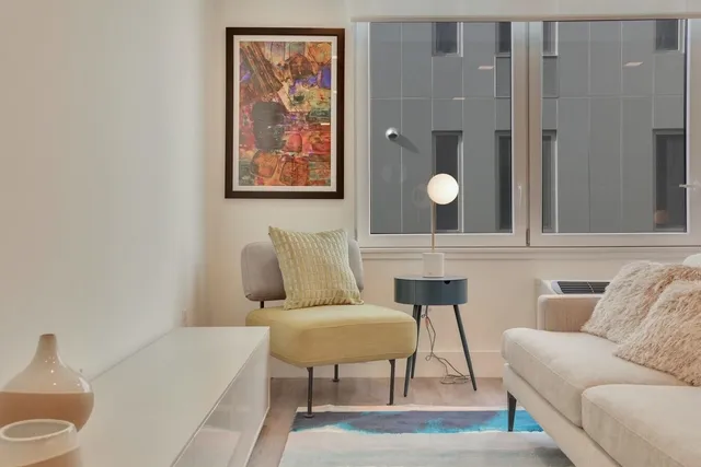 a living room with furniture and lamp