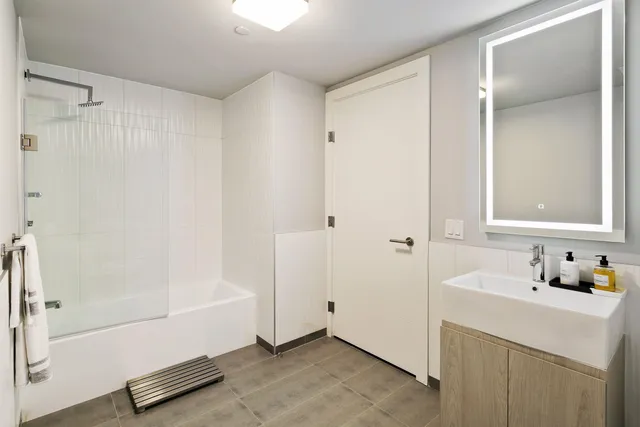 a bathroom with a bathtub and a shower