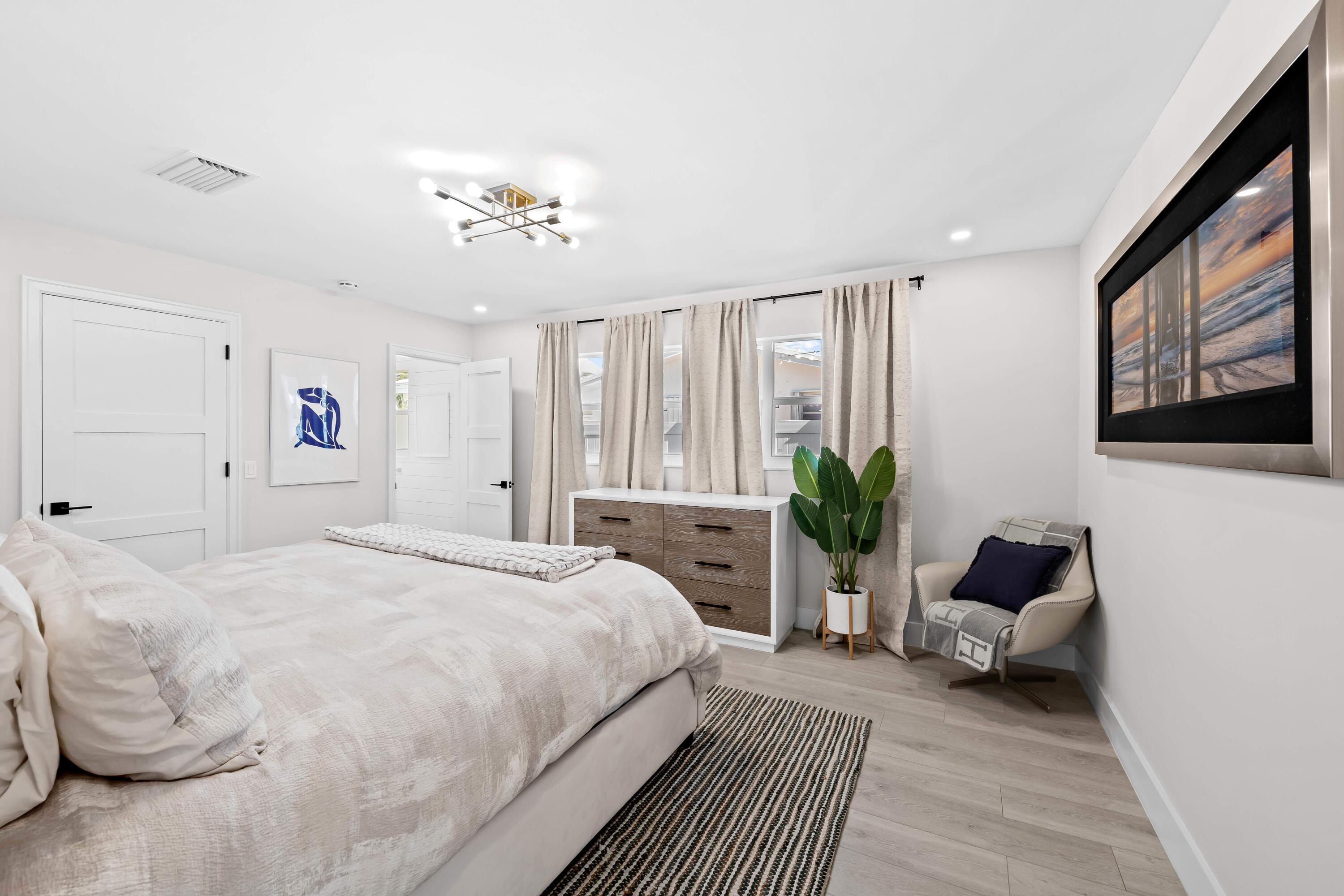 698 West Camino Boca Raton, FL 33486 - Photo 14 of 30 a spacious bedroom with a bed couch and a window