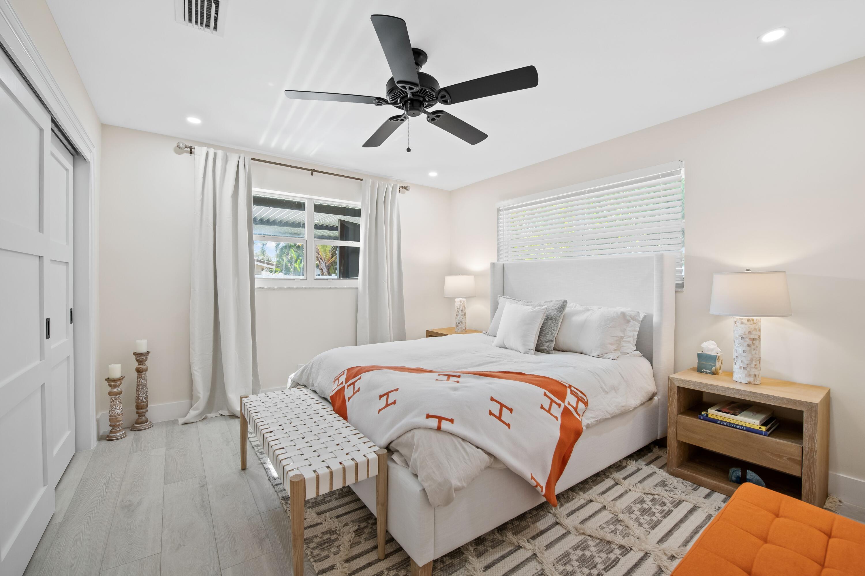 698 West Camino Boca Raton, FL 33486 - Photo 20 of 30 a bedroom with a bed and a ceiling fan