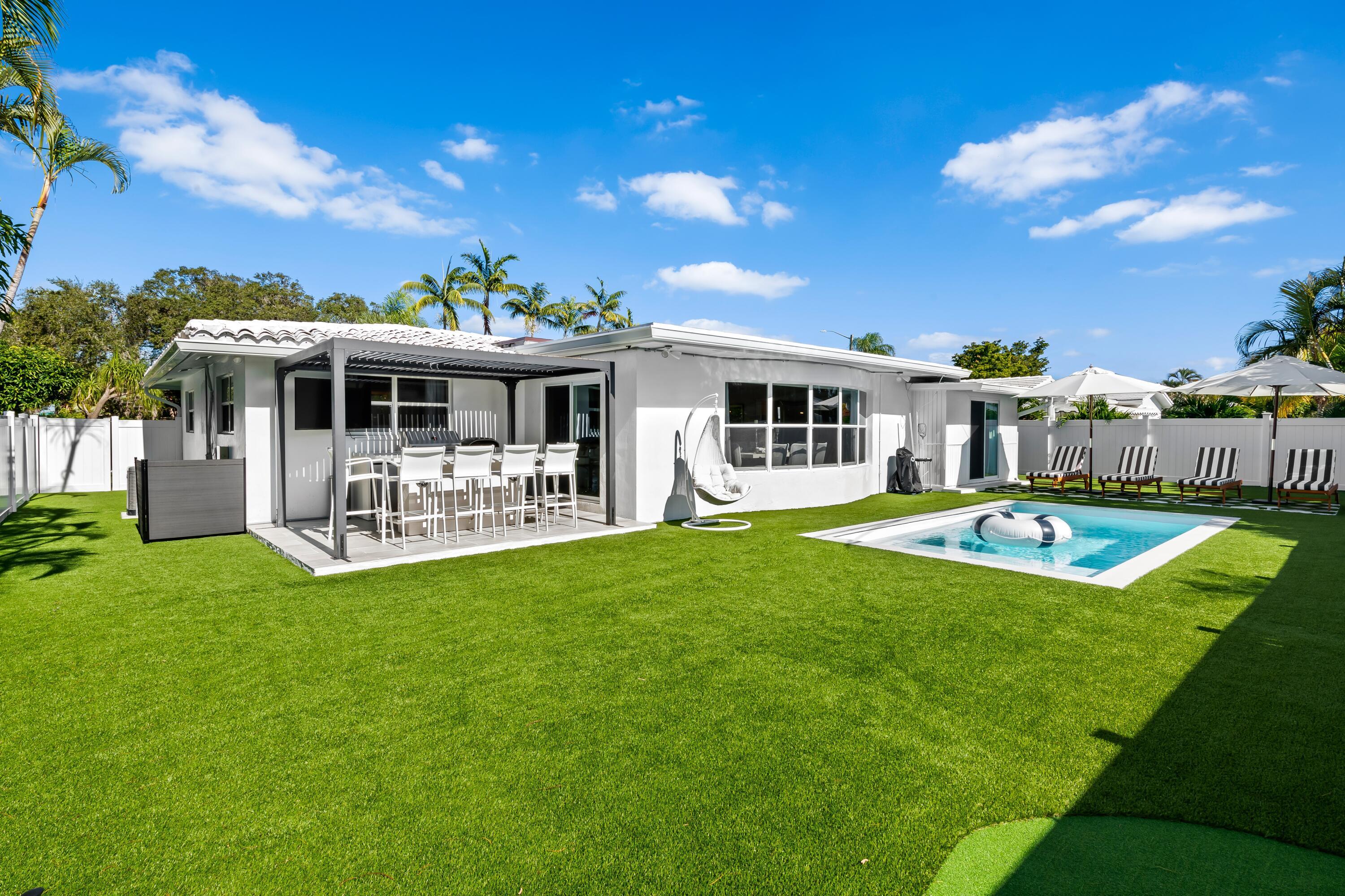 698 West Camino Boca Raton, FL 33486 - Photo 2 of 30 a view of a house with a backyard patio and swimming pool
