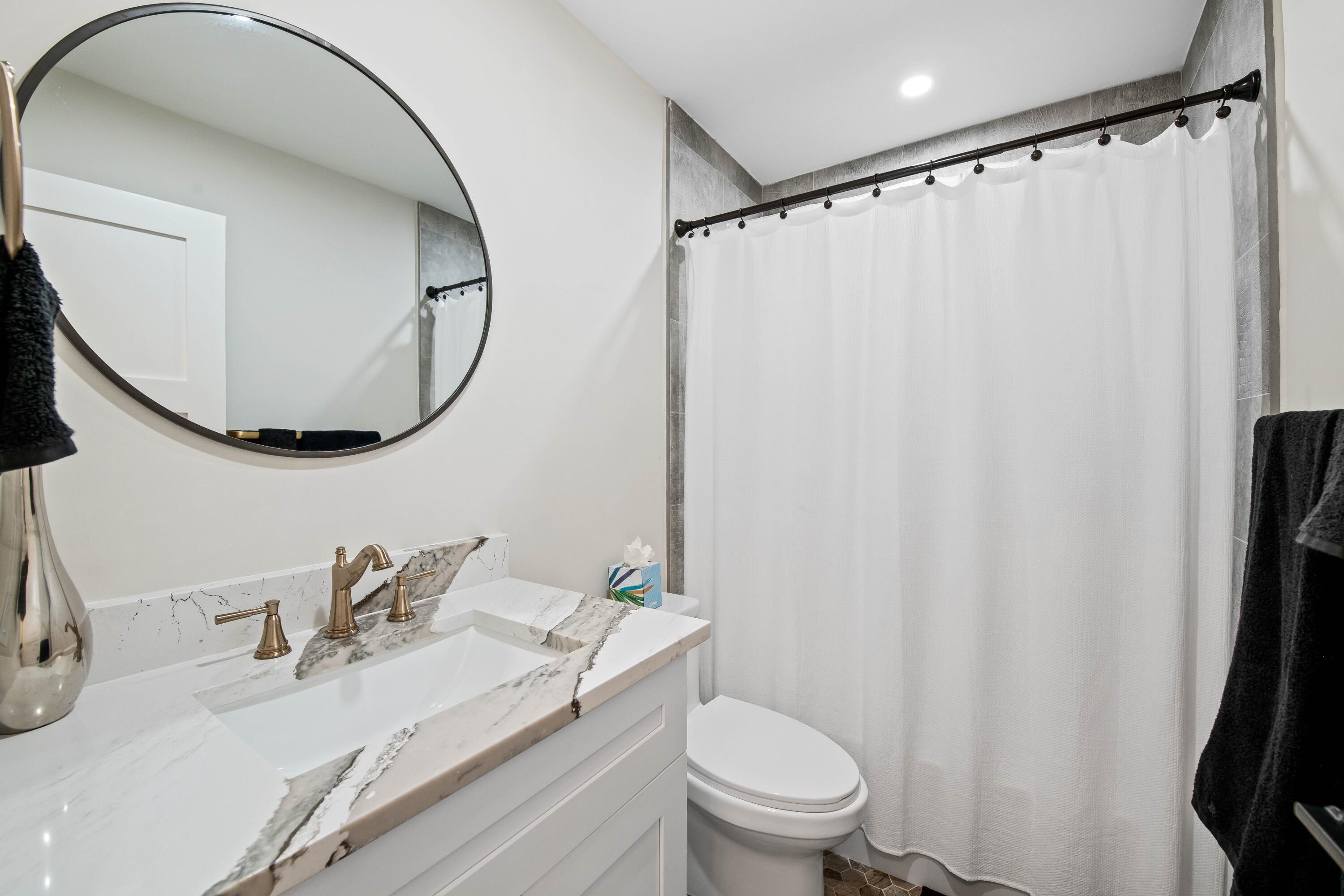 698 West Camino Boca Raton, FL 33486 - Photo 21 of 30 a bathroom with a granite countertop sink toilet and a mirror