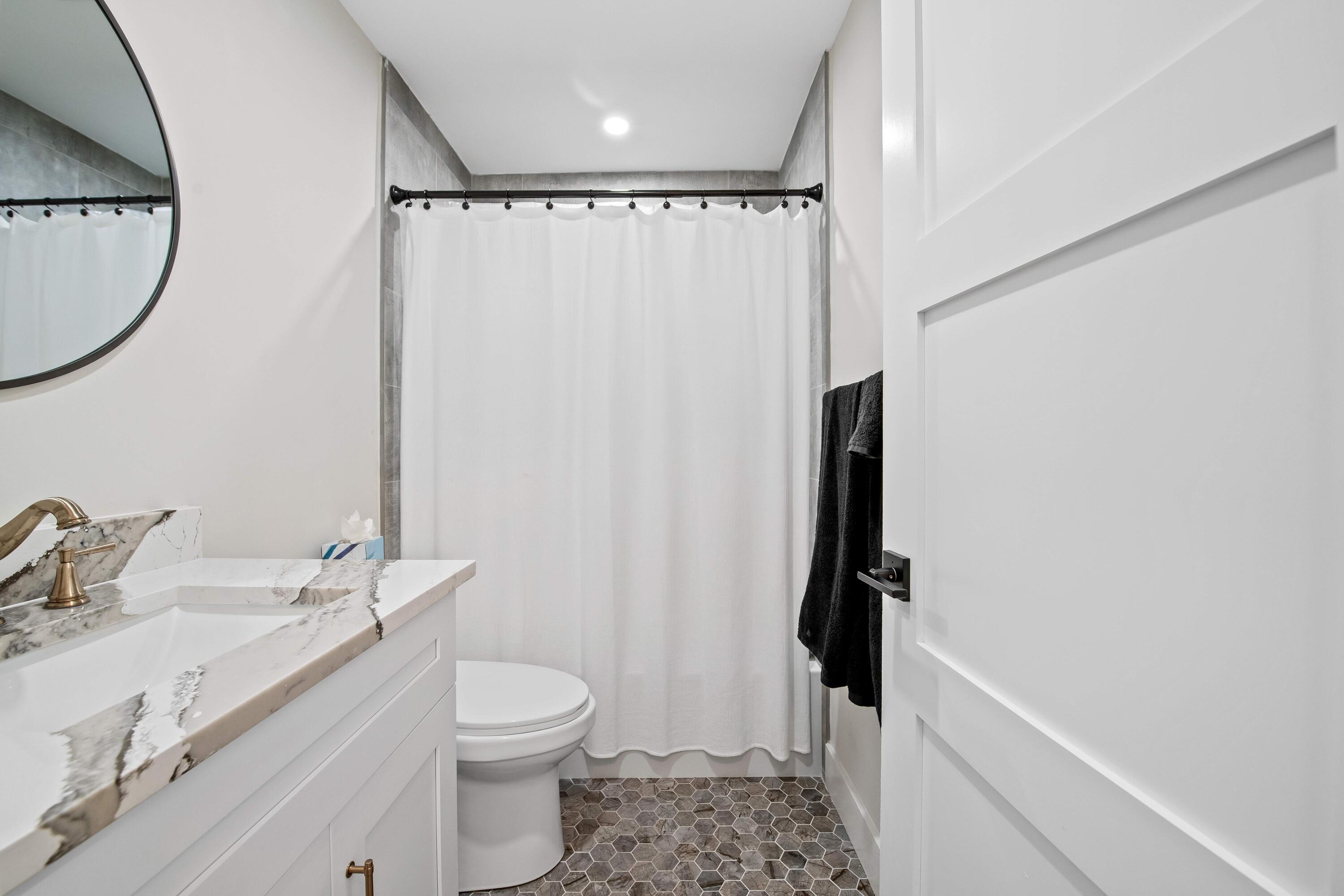698 West Camino Boca Raton, FL 33486 - Photo 22 of 30 a bathroom with a granite countertop sink toilet and shower