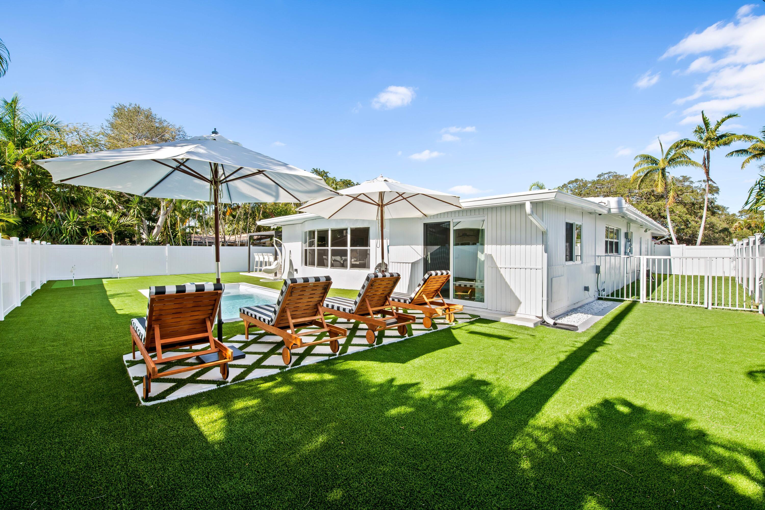 698 West Camino Boca Raton, FL 33486 - Photo 25 of 30 a view of a house with backyard sitting area and garden