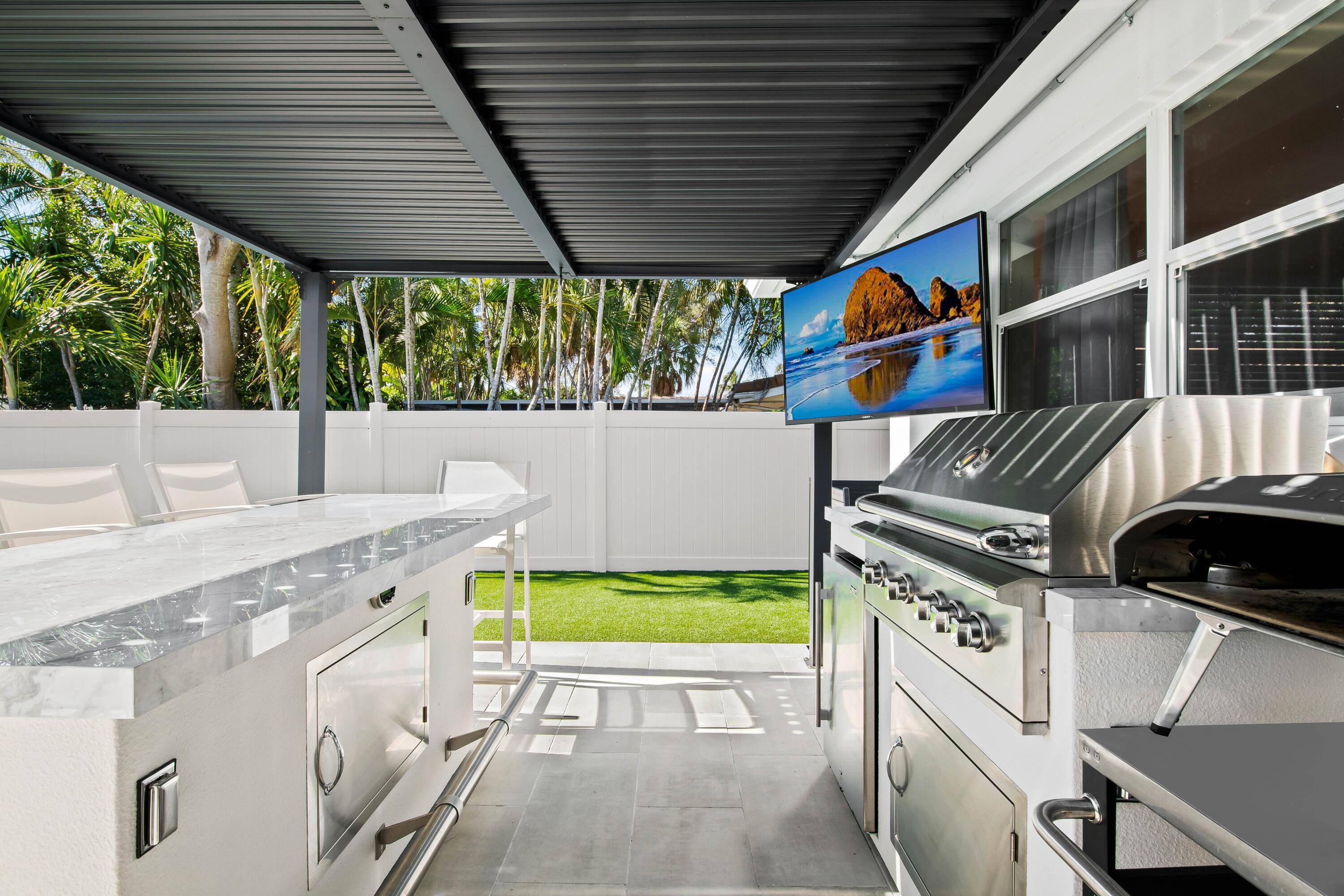 698 West Camino Boca Raton, FL 33486 - Photo 27 of 30 a view of a patio with a table and chairs