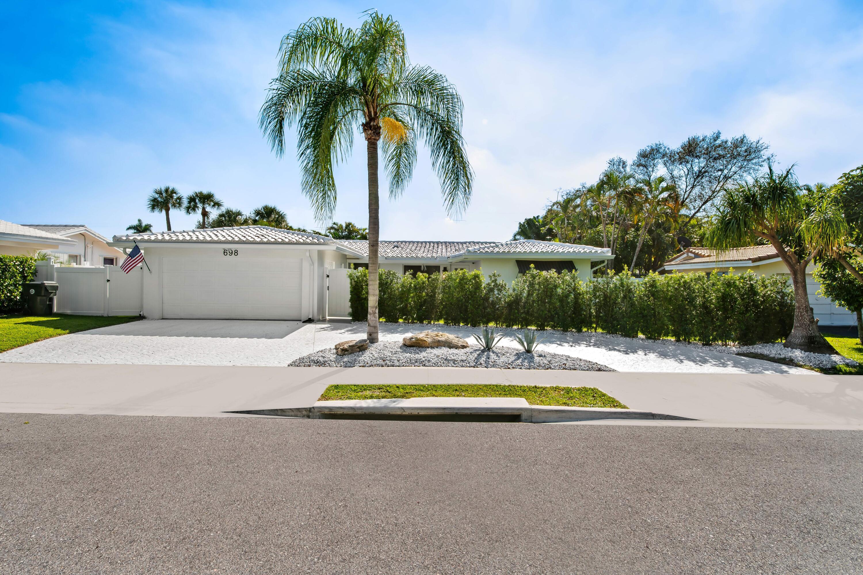 698 West Camino Boca Raton, FL 33486 - Photo 30 of 30 a view of a swimming pool with a yard and palm trees