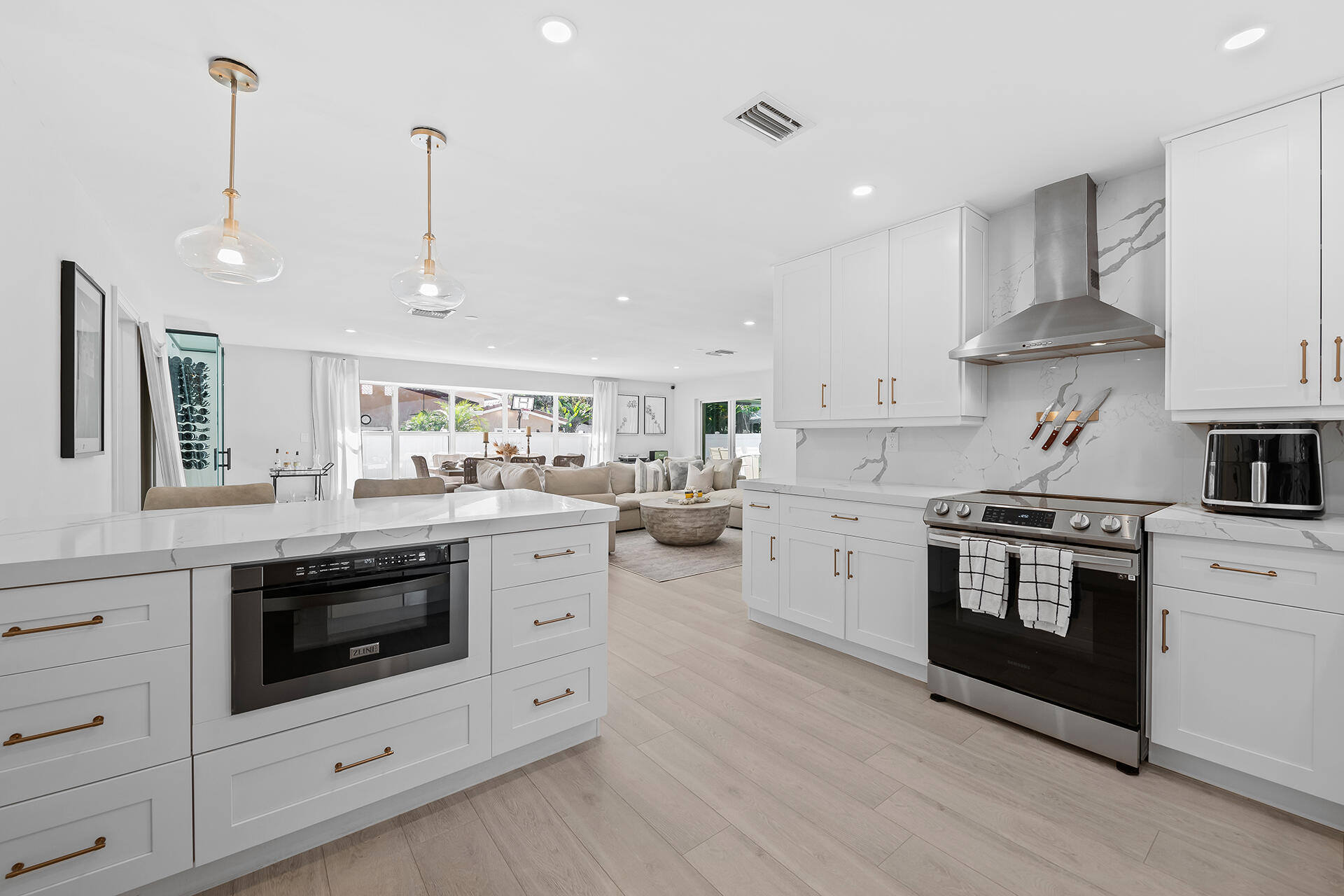 698 West Camino Boca Raton, FL 33486 - Photo 9 of 30 a kitchen with stainless steel appliances granite countertop a stove a sink and a wooden floors