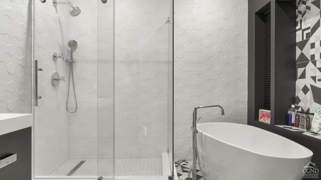 a bathroom with a sink mirror and shower
