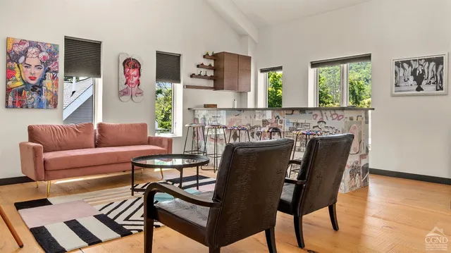 a room with pool table and windows