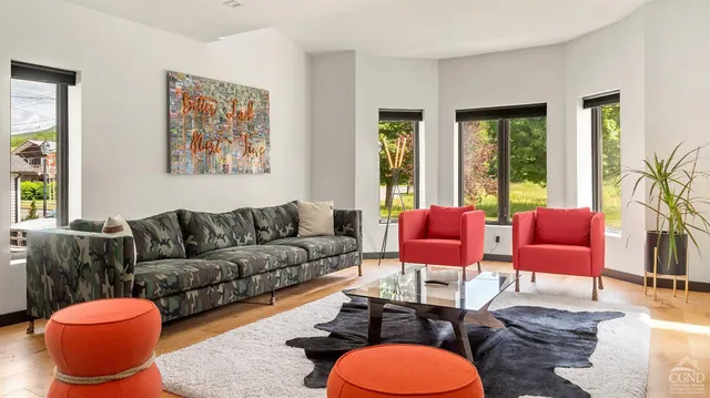 a living room with furniture a rug and a lamp