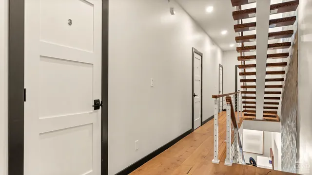 an aerial view of residential houses with outdoor space and trees all around