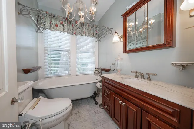 a bathroom with a granite countertop toilet a sink and bathtub