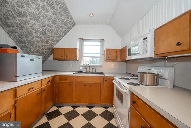a kitchen with stainless steel appliances granite countertop a sink and cabinets