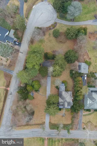 an aerial view of a house with a yard and garden