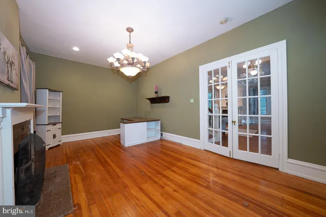 a bedroom with furniture chandelier and wooden floor