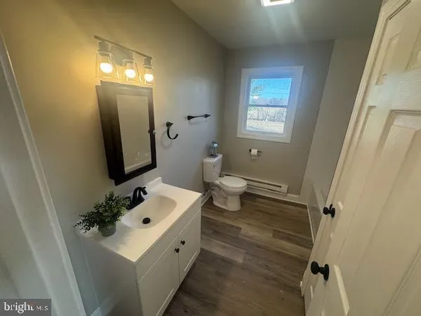 a bathroom with a sink toilet and mirror