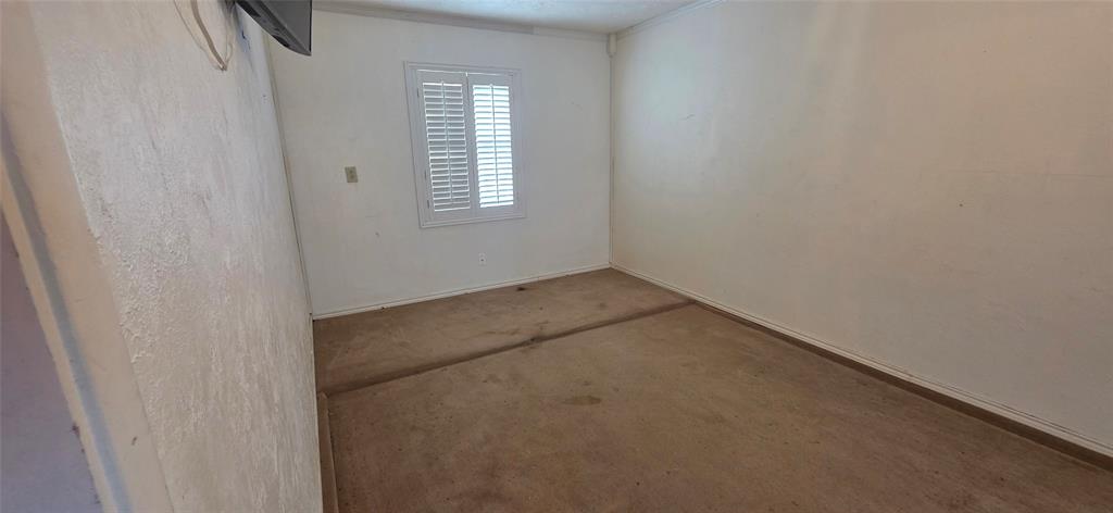 1323 Timberview Drive Allen, TX 75002 - Photo 12 of 14 Neutral wall paint, window with white plantation shutters, and light-toned carpet flooring
