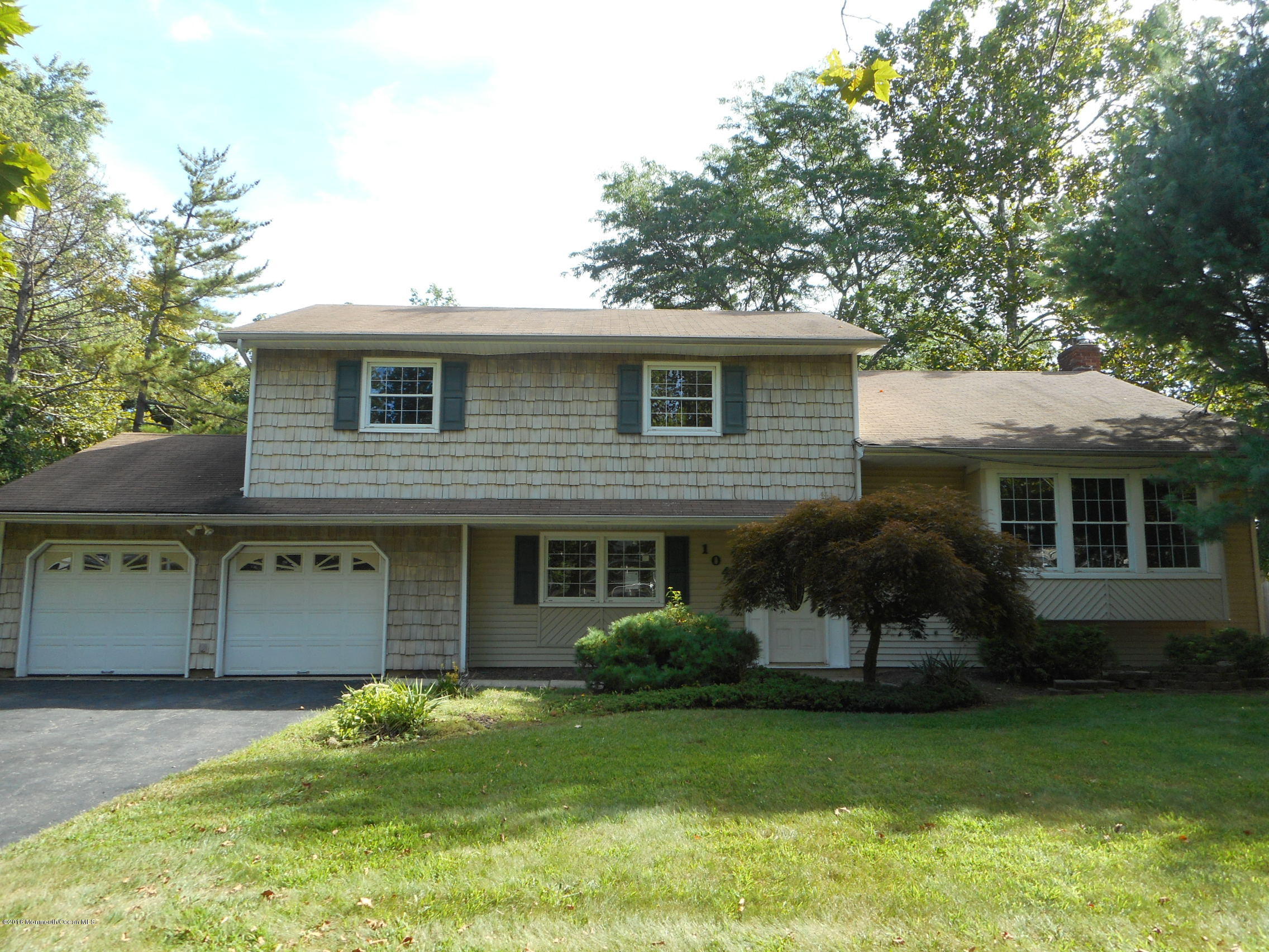 104 Bar Harbor Road Freehold, NJ 07728 - Photo 1 of 18 a front view of a house with a garden and plants