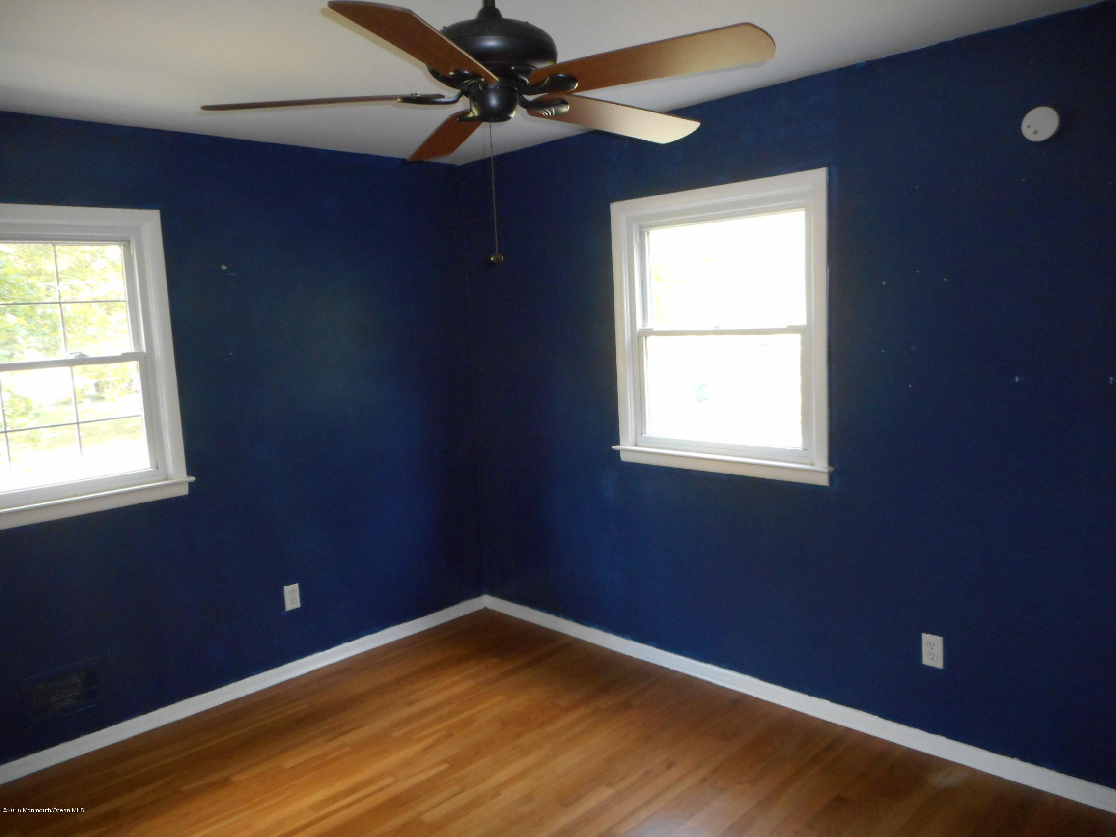 104 Bar Harbor Road Freehold, NJ 07728 - Photo 7 of 18 an empty room with a window and a fan