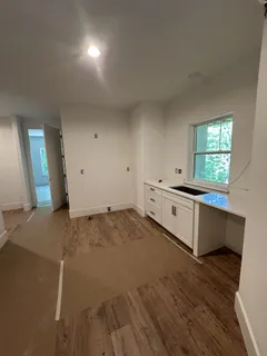 a kitchen with a stove and white cabinets