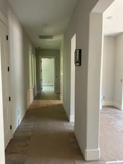 a view of a hallway with wooden shelves