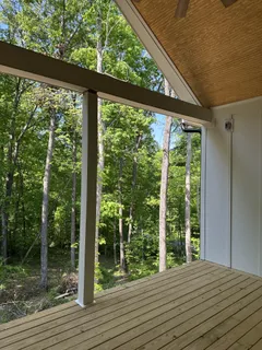 a view of a balcony with wooden floor
