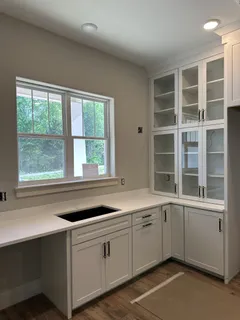 a kitchen with a sink and large window