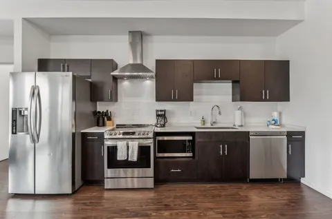 a kitchen with stainless steel appliances and wooden cabinets
