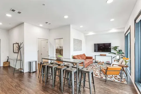 a view of a a dining room with furniture window and wooden floor